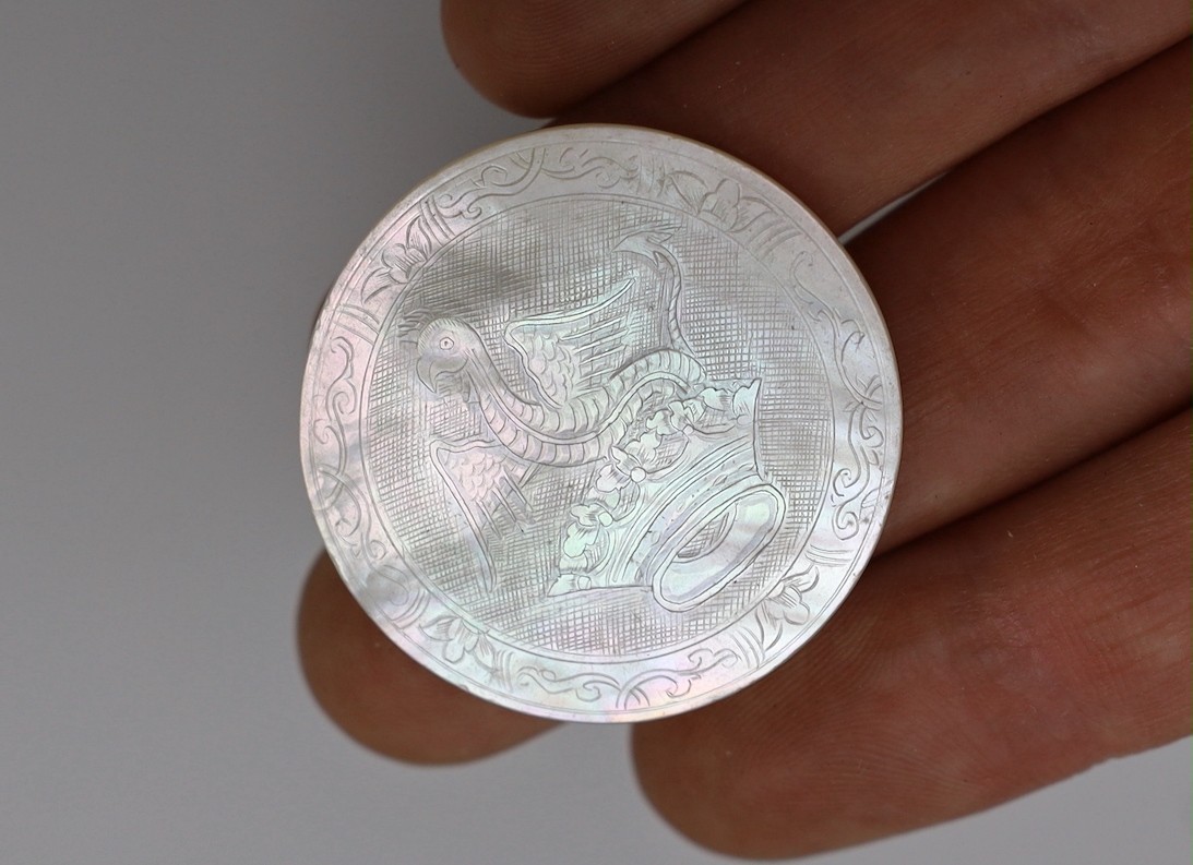 Approximately 135 Chinese carved mother of pearl counters of varying shapes, 19th century